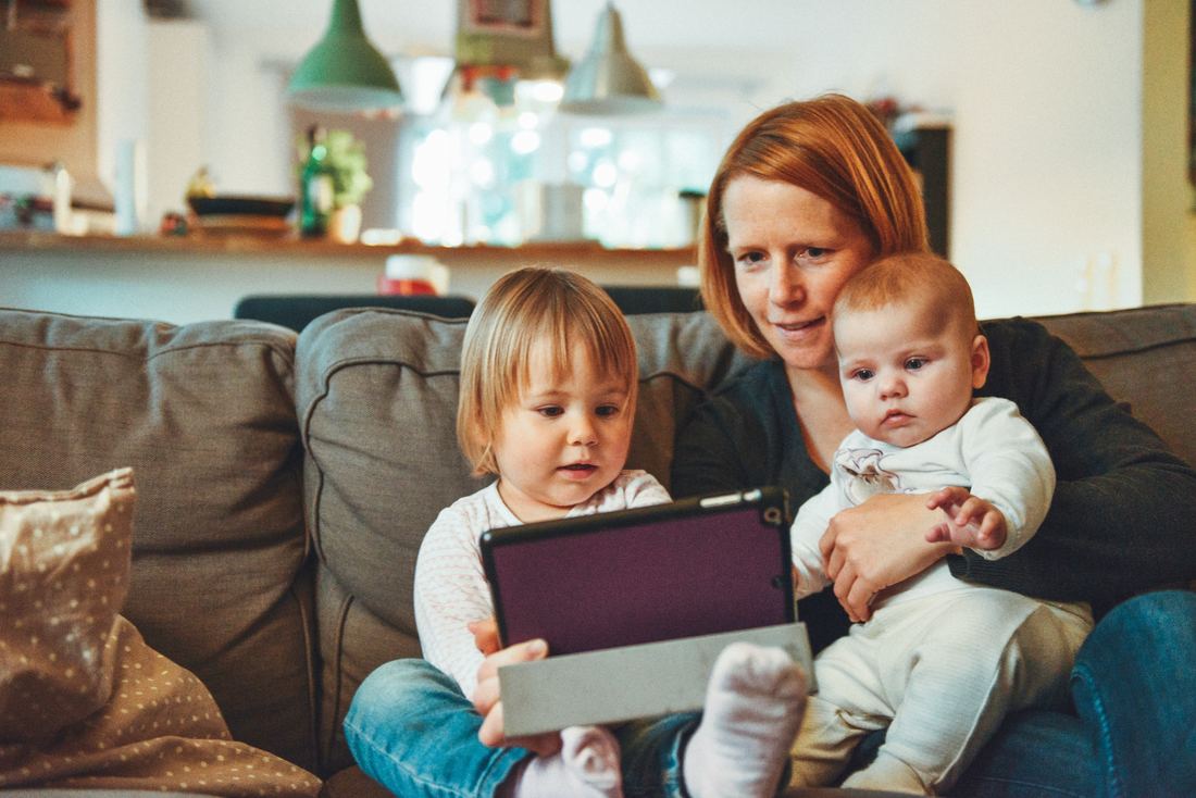 A mother is teaching her young child healthy technology habits